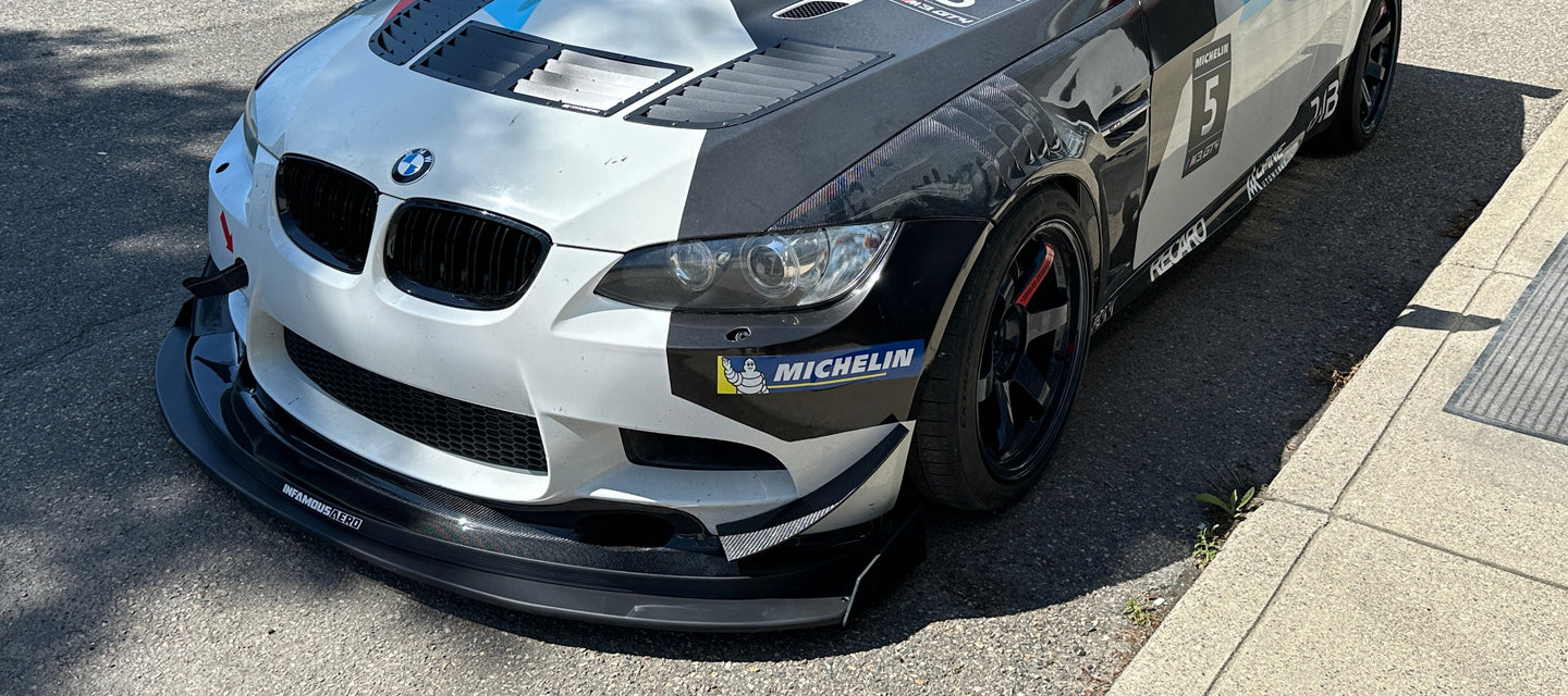 BMW race car with visible branding on a street